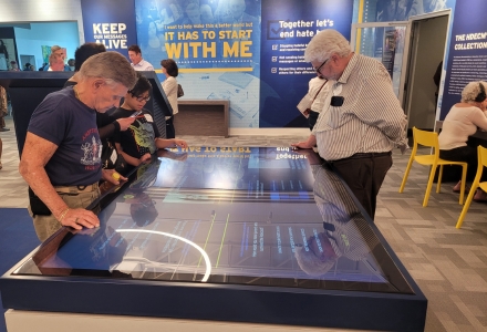 Visitors of the HDEC’s Interactive Learning Center engaging in touch interaction and experiencing stories from the Holocaust through the digital assets produced by IDEx. (Photo courtesy of Dr. Davide Tanasi)