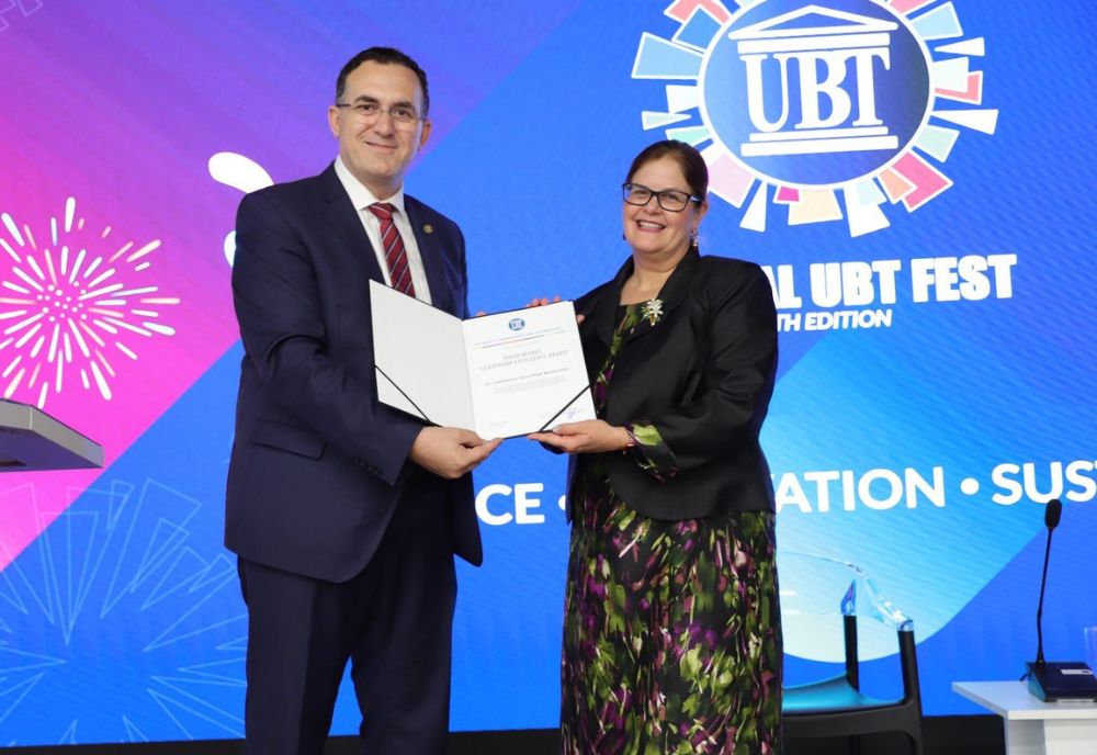 Dr. Judithanne Scourfield McLauchlan (right) receives the Leadership Excellence Award from UBT Rector Edmond Hajrizi (left). (Photo courtesy of Judithanne Scourfield McLauchlan)