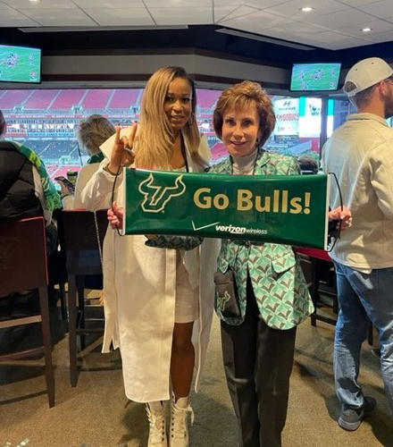 Monique D. Hayes (left) with former USF president Judy Genshaft (right), in attendance at a USF football game. (Photo courtesy of Monique D. Hayes)