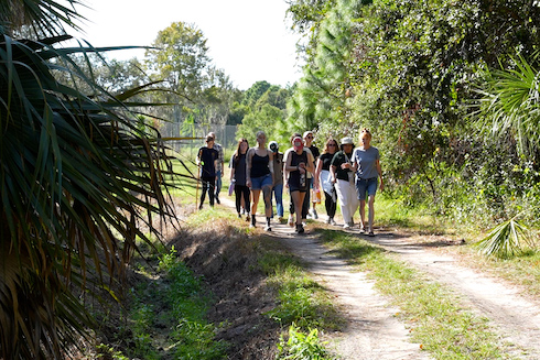 students walk on a path in Boyd Hill Nature Preserve