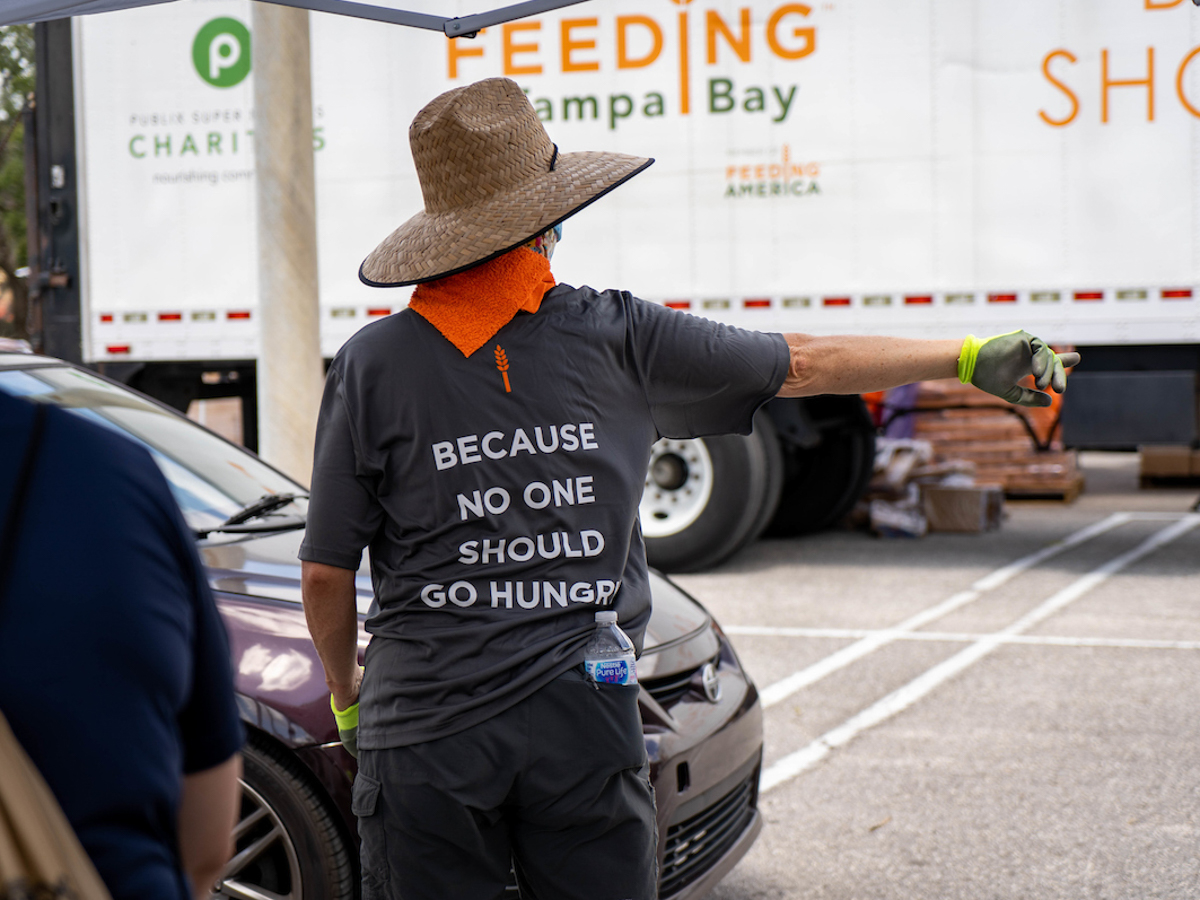person pointing towards semi-truck for Feeding Tampa Bay
