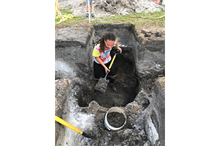 Undergraduate student excavates the privy discovered during excavations during the USF Archaeological Field School