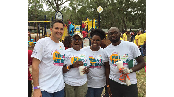 Four people at a celebration of a redevelopment project