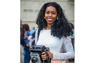 Photo of Nadege Nau holding a camera