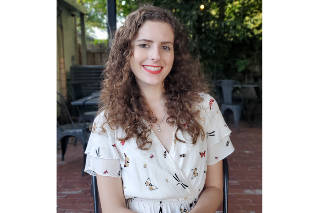 Headshot of MFA alumna Courtney Clute smiling into the camera