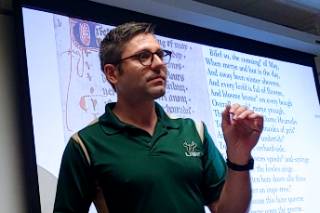 image of Elan Pavlinich speaking in front of a projector screen