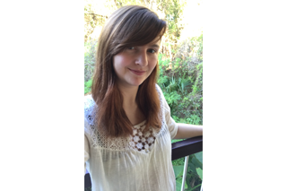 Headshot of graduate student Erika Staiger in front of a wooded area