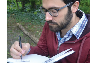 an image of Jarod Rosello writing in a journal