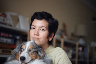 Headshot of Jackie Carlson holding her dog