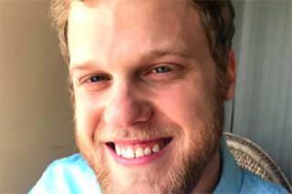 Headshot of Nicholas Brown smiling into the camera