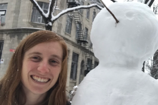 Headshot of Adrianna Melillo smiling into the camera next to a snowman