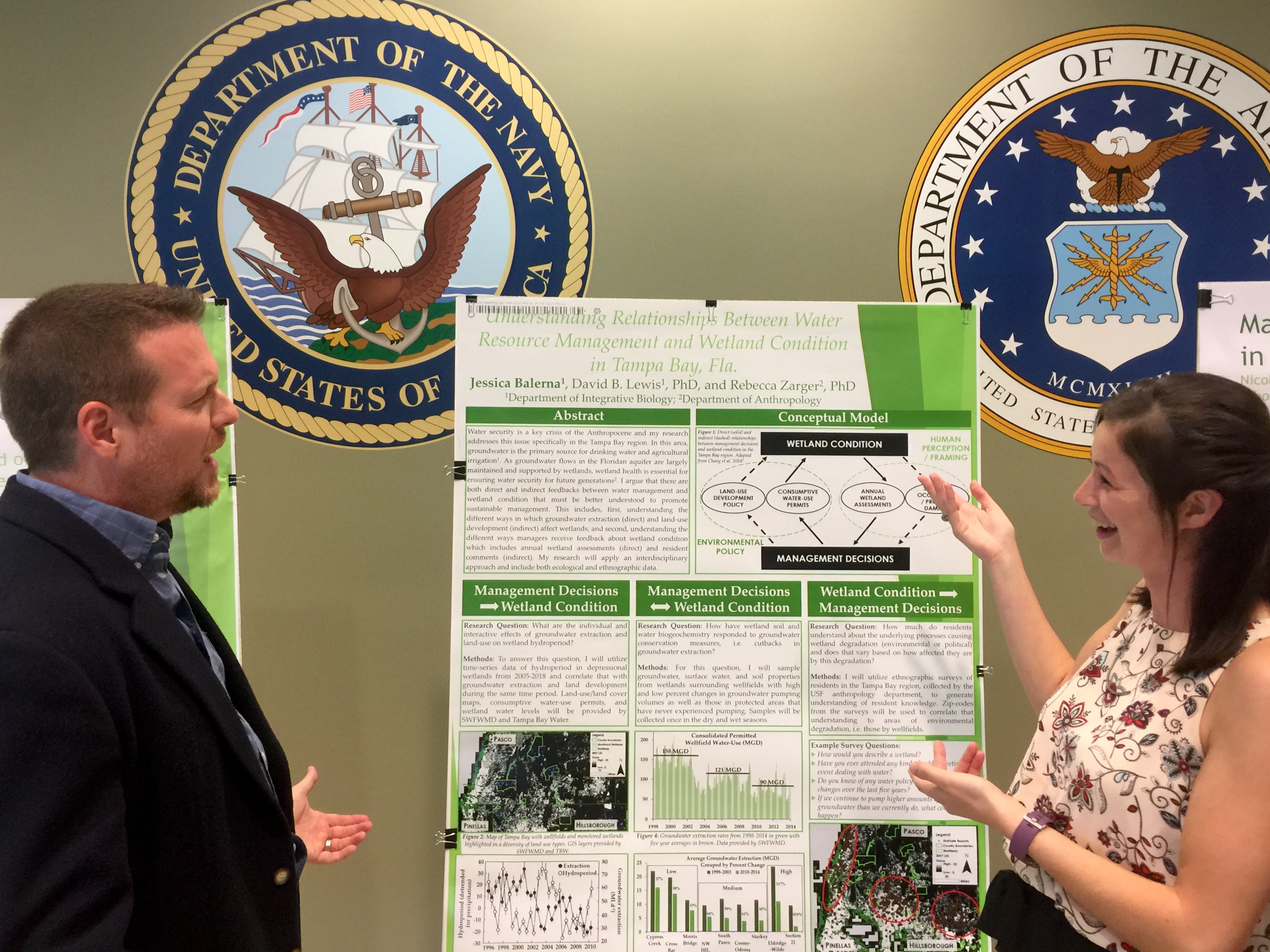 Student showcasing research poster.