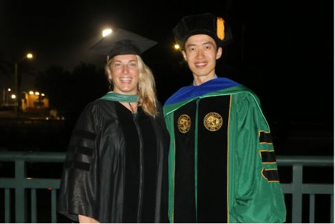 Dr. Jennifer Collins (left) and Yijie Zhu (right) after a graduation ceremony.