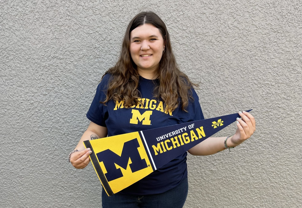 Abigail reed holding University of Michigan gear