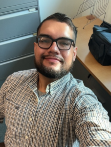 man headshot with desk behind him