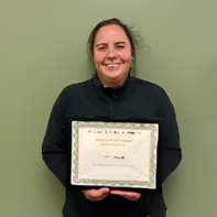 Maria Ceron holding her award plaque
