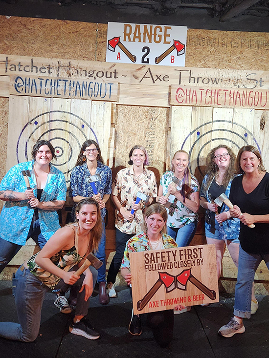 group holding axes at ax throwing venue