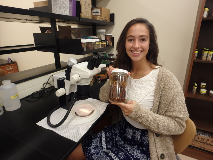 student holding specimen jar