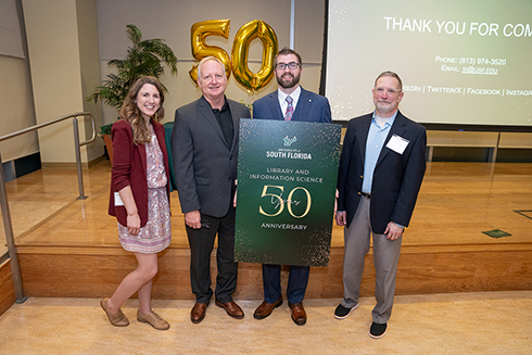 (From left) LIS program director Natalie Taylor, associate director of the iSchool Jim Andrews, department operations manager David Chapel, and iSchool director Randy Borum at the 50th anniversary event. (Photo by Corey Lepak)
