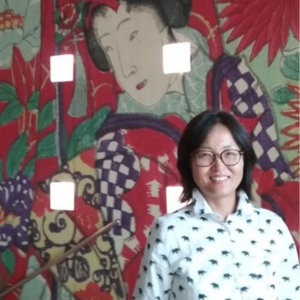 Dr. Loni Hagen in front of a japanese mural