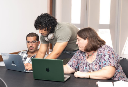 Dr. Vandewall and 2 others looking at a computer