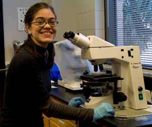 student using microscope