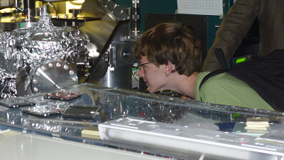 Student viewing physics experiment