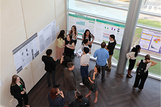 View looking down in one corner with poster presenters and attendees