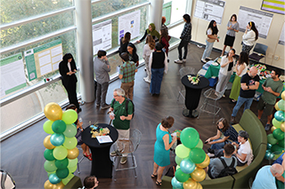 View looking down in one corner with poster presenters and attendees