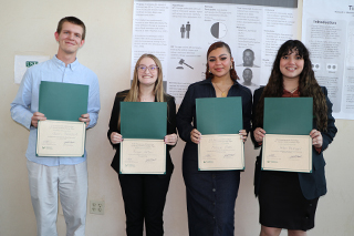 Four student poster winners holding their certificates