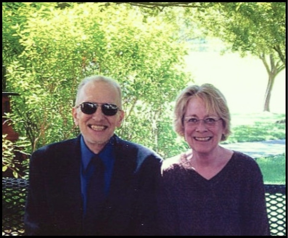 Drs. Spencer Cahill and Donileen Loseke sitting on a bench