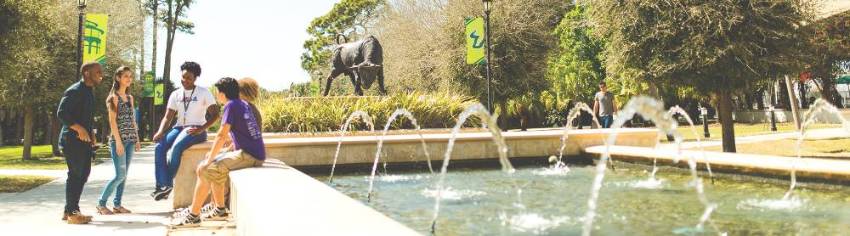 group of students beside a fountain