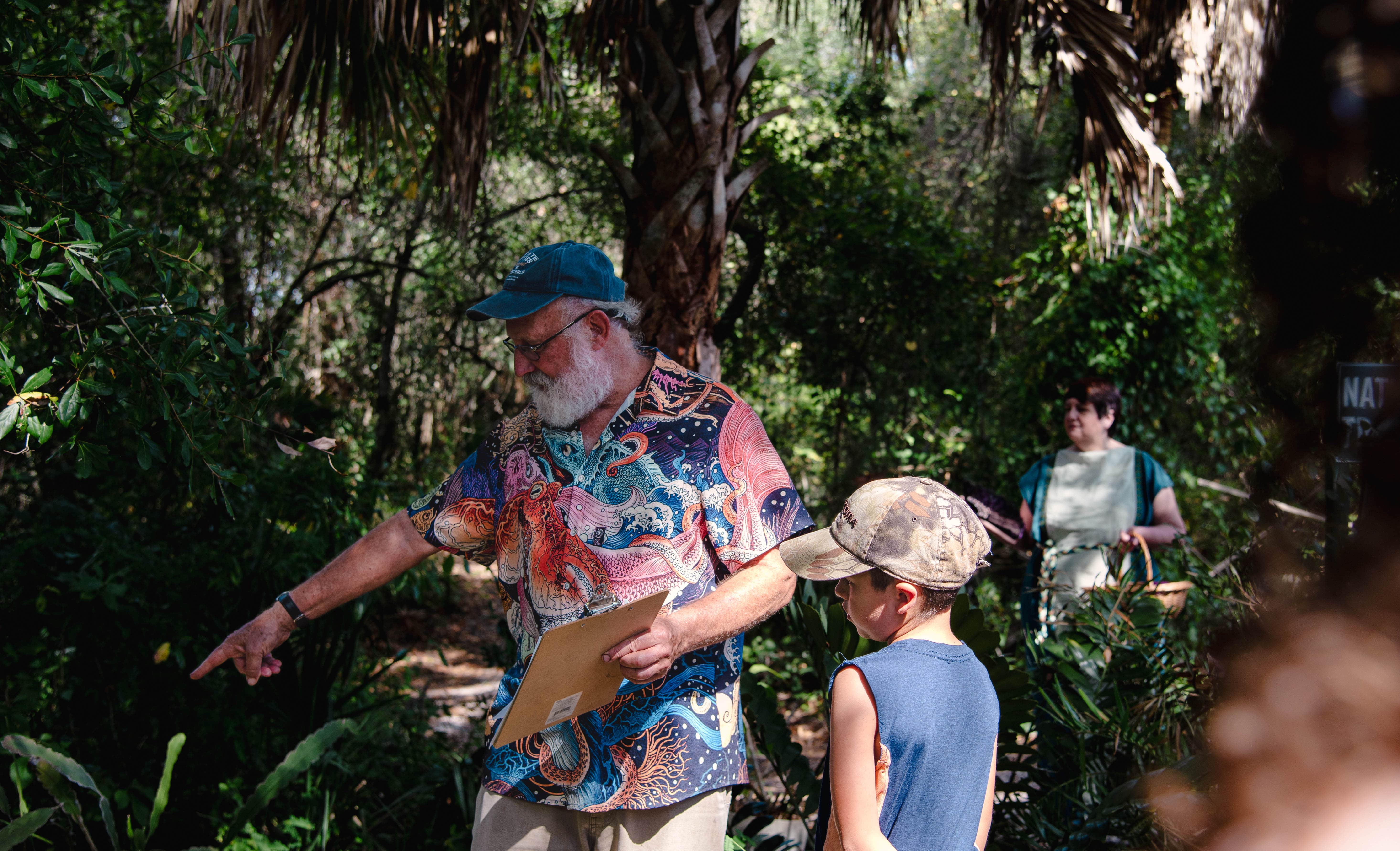 Picture of Plant Curator Craig pointing out plants