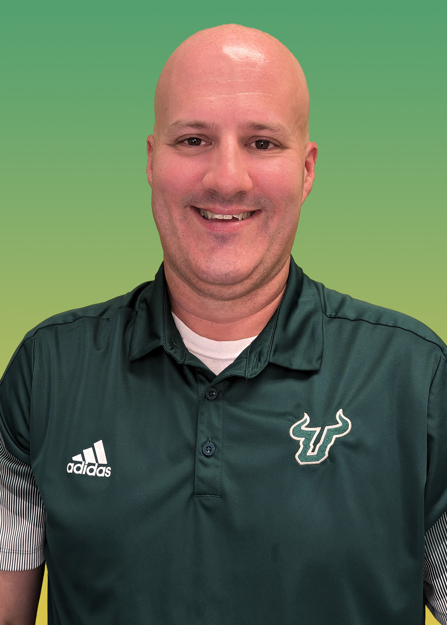 Portrait of Chris Kerr wearing a green USF polo shirt. 