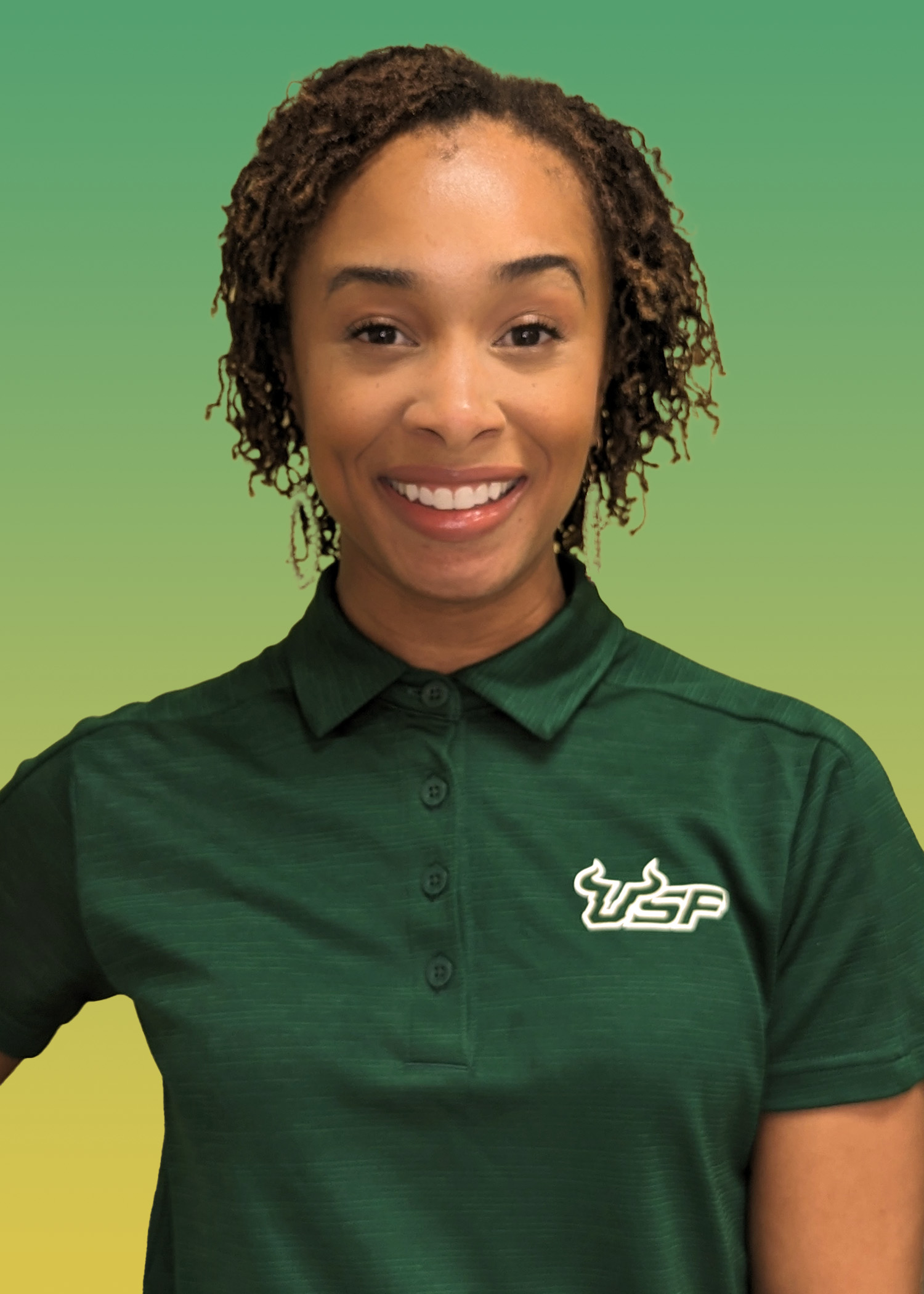 Portrait of Desarae Pointer wearing a green USF polo shirt. 