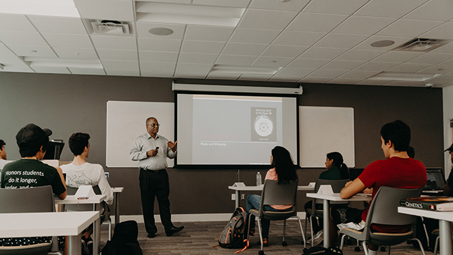 Dr. Melvin James in front of students