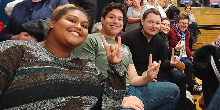 Students seated with Josh Scacco at an event