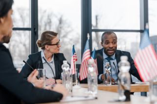 people seated at table with small American flags