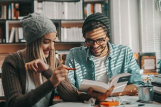 two students studying and laughing