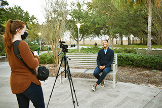 Student intern filming a video