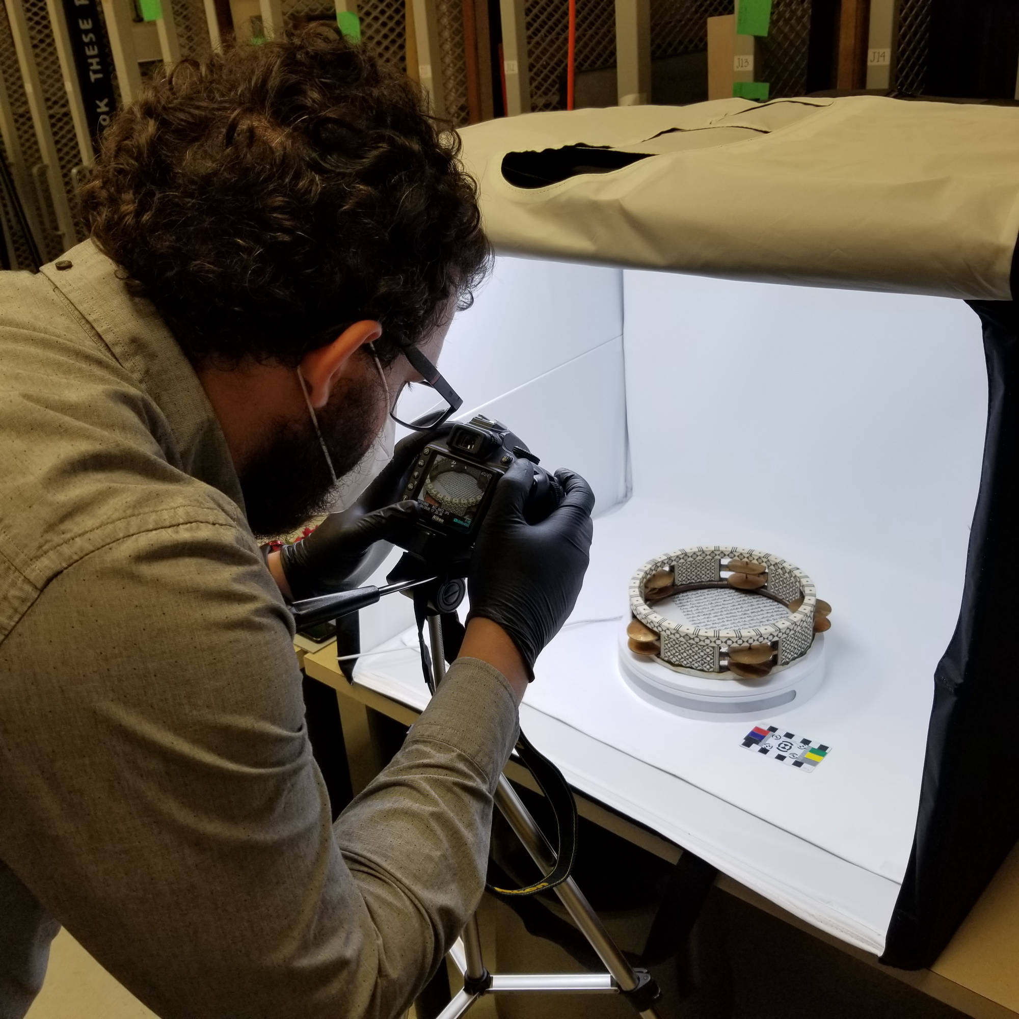 man photographing tambourine