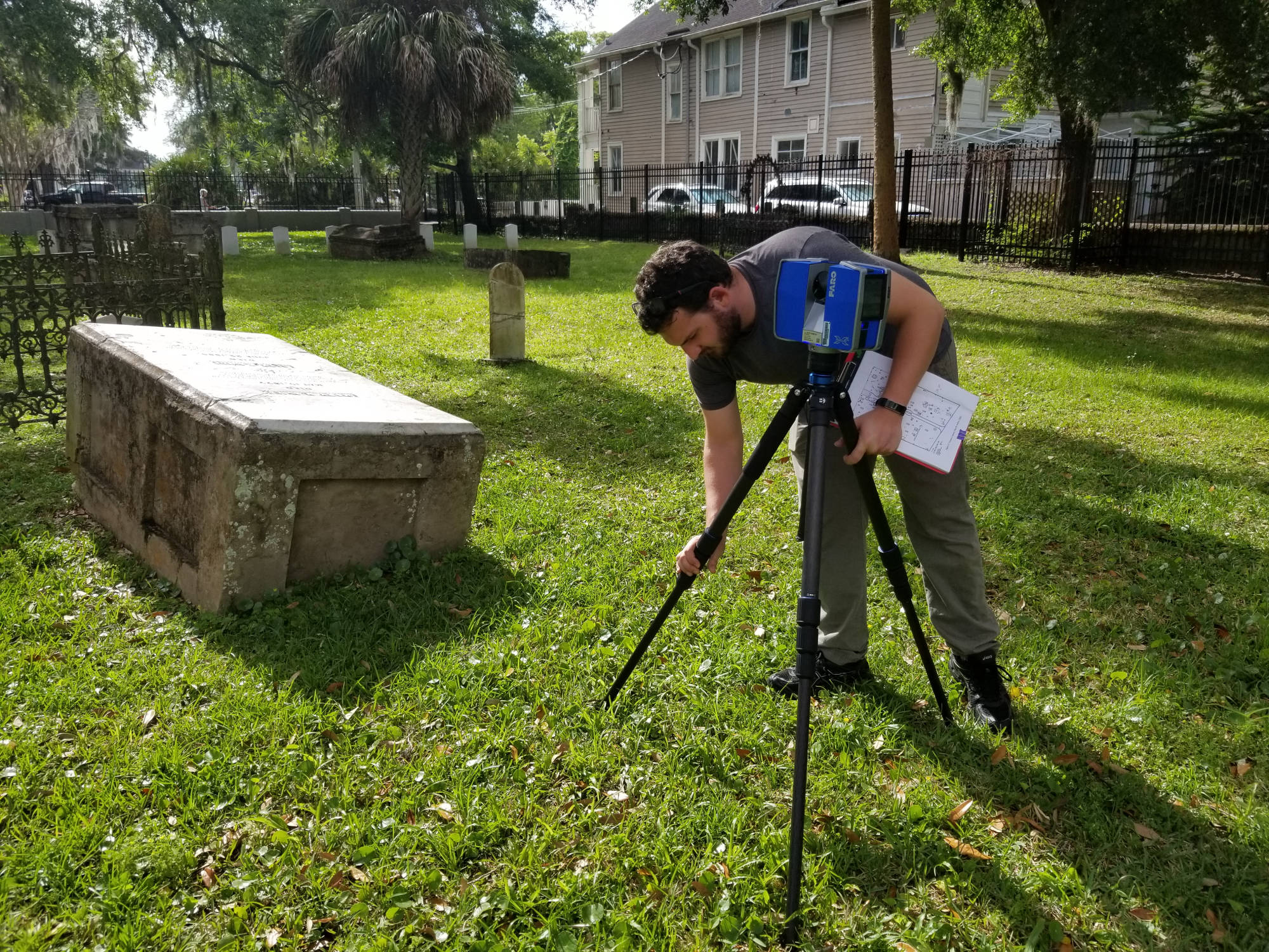 student setting up equipment in cemetery