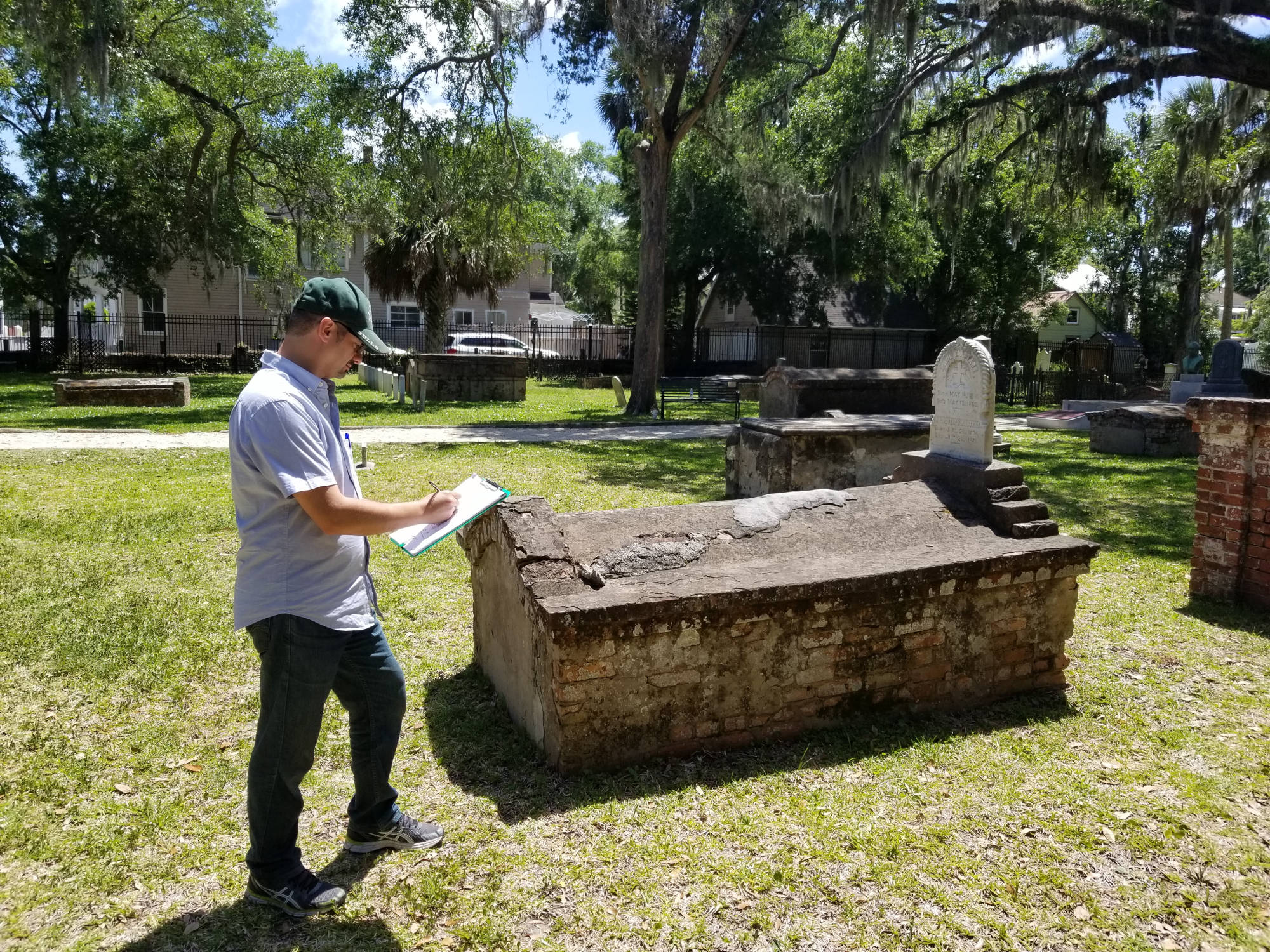 student viewing tomb in cemetery