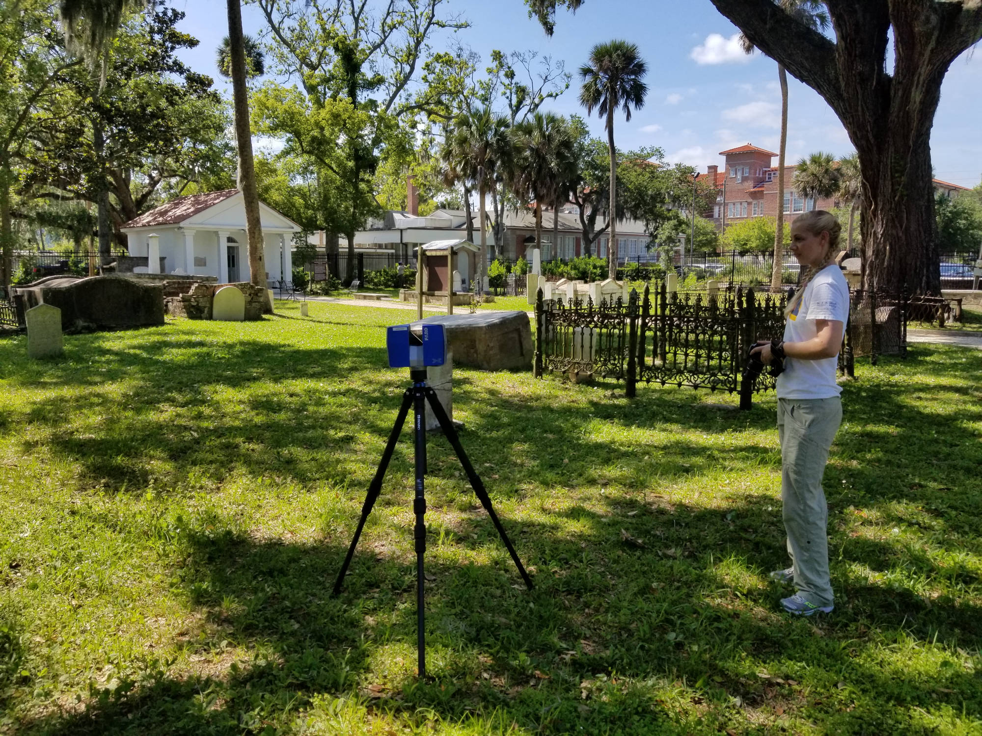 student with equipment in cemetery