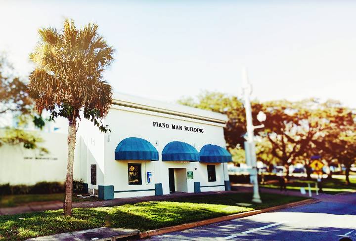 view of the front door of the usf piano man building from the street