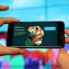 A person holds a smartphone horizontally, looking at a new USF-developed app. 