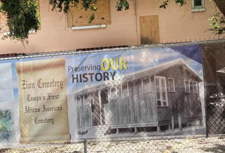 Memorial banner recognizing the site of Zion Cemetery, which is now Robles Park Village public housing development