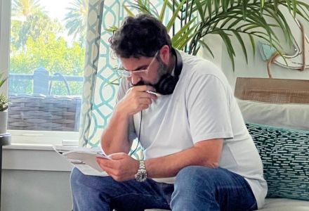 Mario Garcia reviewing documents on the set of “The Throwback”. (Photo courtesy of Mario Garcia)