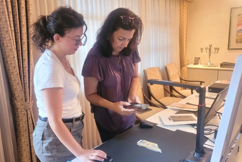 IDEx team members digitizing a Star of David badge sewn onto a piece of a concentration camp prisoner’s uniform. (Photo courtesy of Dr. Davide Tanasi)