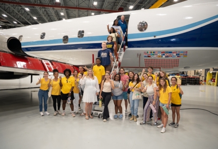 Dr. Jennifer Collins, professor in the School of Geosciences and principal investigator on Weather, Climate, and Society REU, with two REU groups at USF this summer, one from the Tampa campus, and one from the St. Petersburg campus, on a P-3 Orion plane which is used to fly into hurricanes. (Photo by Corey Lepak)